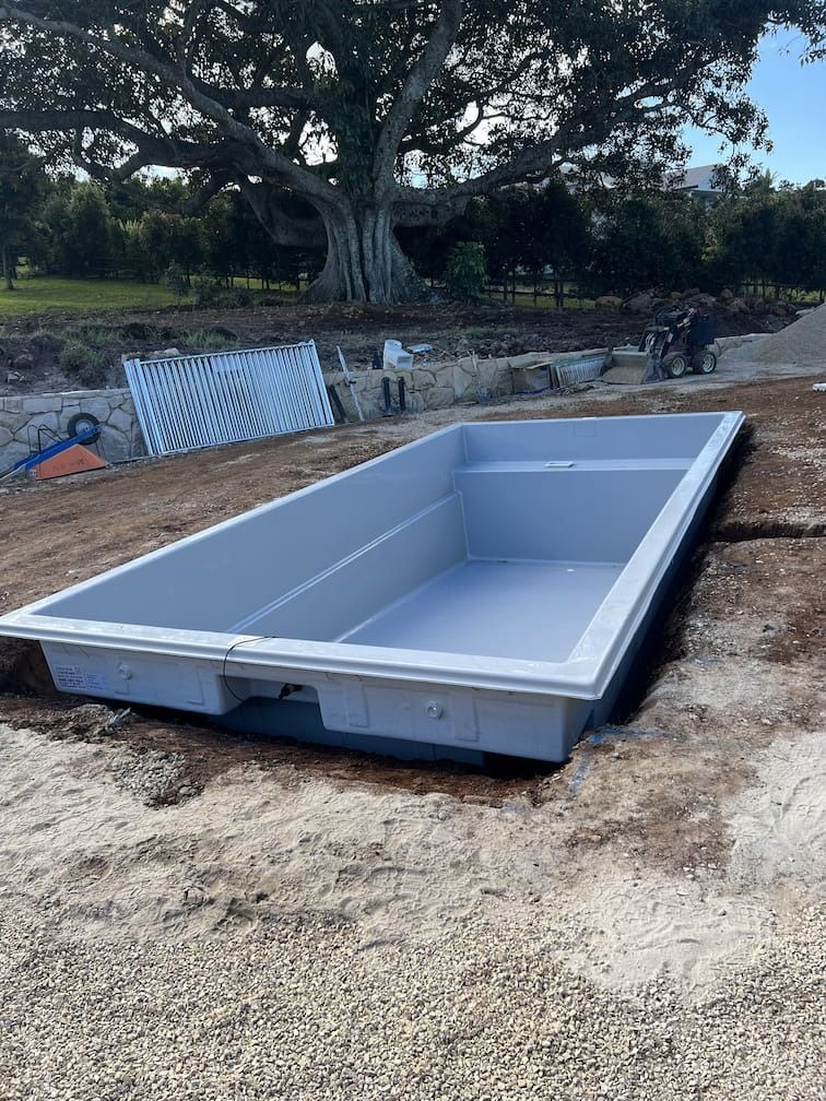 A Rectangular, Light-blue Swimming Pool Shell on a Dirt Surface — Bombs Away Pools in Coolangatta, QLD