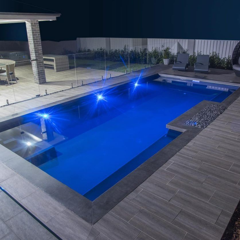 Nighttime View of a Rectangular Pool With Blue Lights — Bombs Away Pools in Coolangatta, QLD