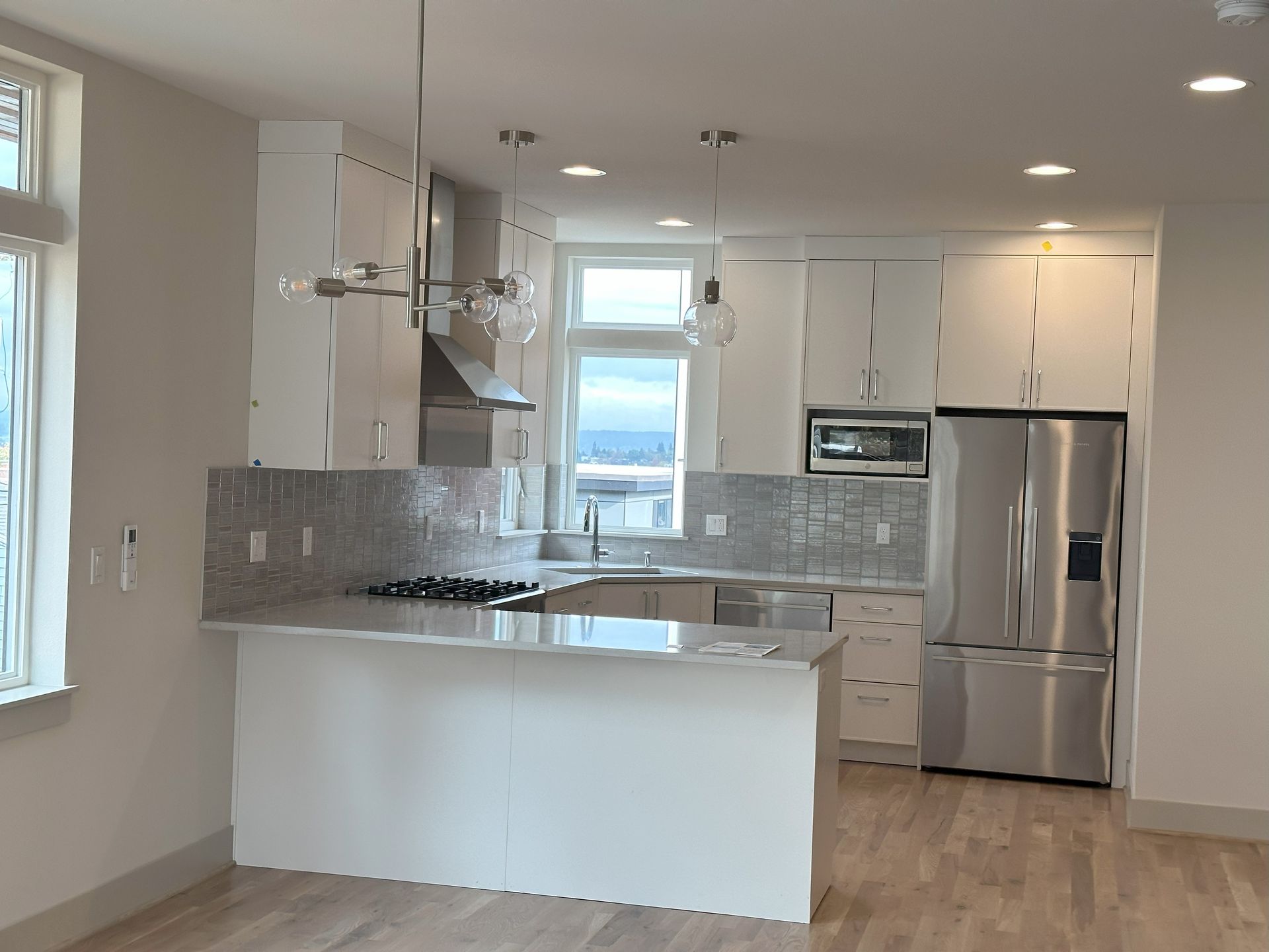 A kitchen with white cabinets and stainless steel appliances