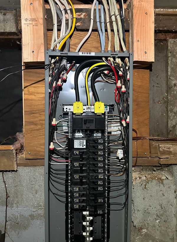 a electrical panel with a lot of wires coming out of it .