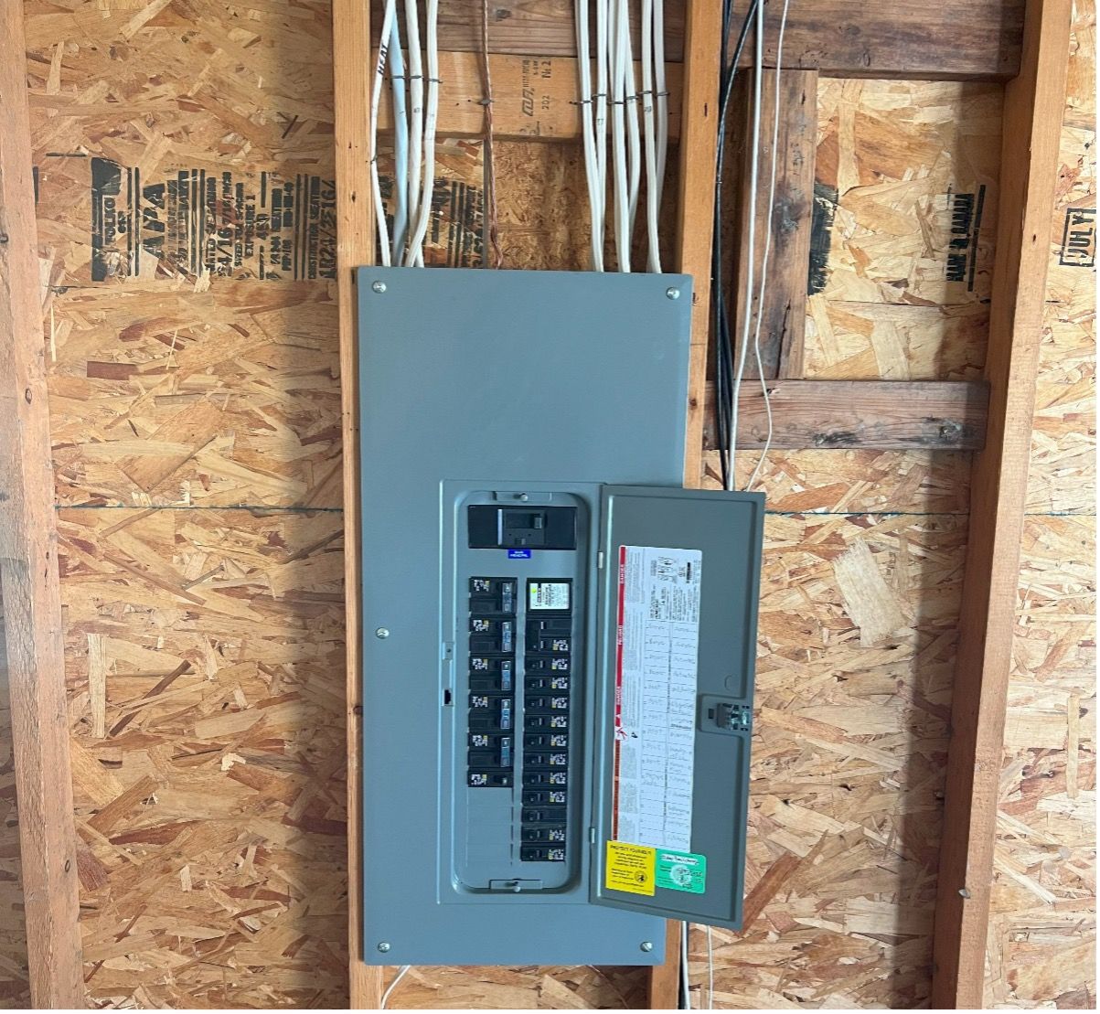 an electrical box is hanging on a wooden wall new replacement by mauro electric in Seattle WA