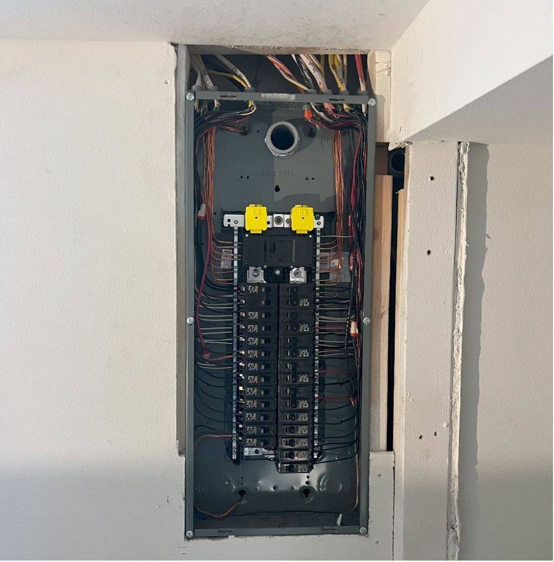 the inside of a electrical box with yellow connectors - panel replacement by mauro electric near seattle