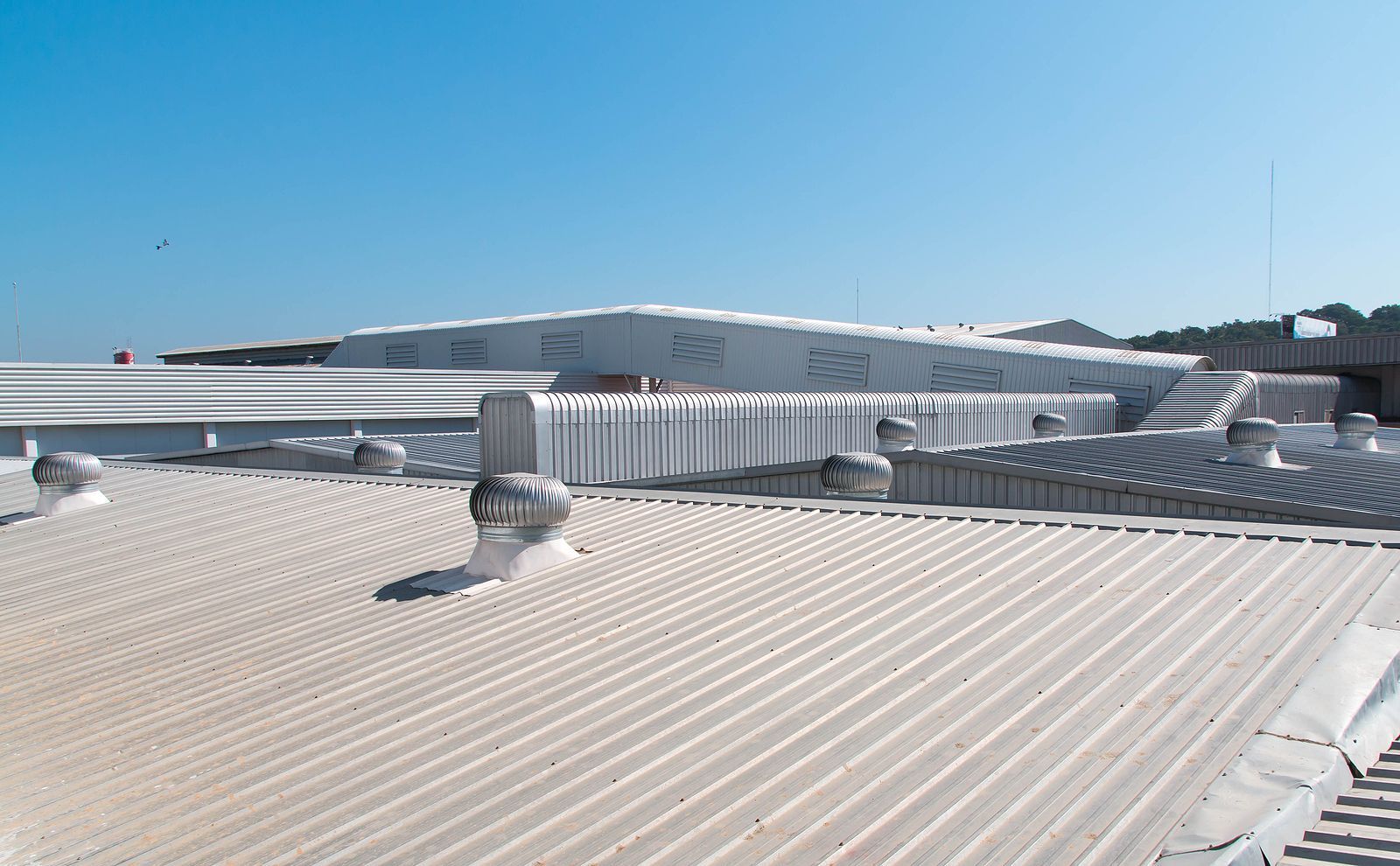 A roof of a building with a blue sky in the background.