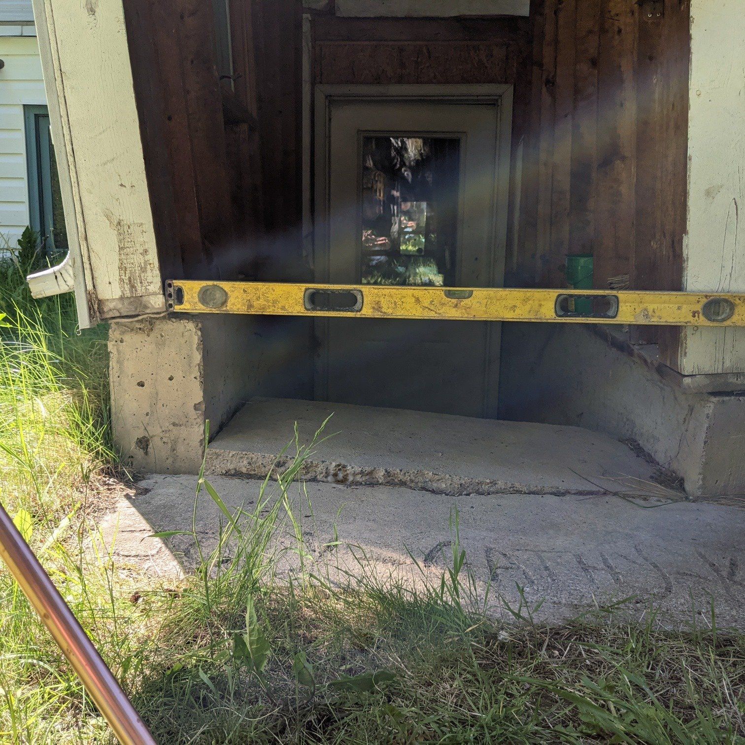 crooked exterior basement entrance and concrete stairs, concrete stair levelling & Repair, slab jacking, best concrete levelling and repair company, prince george bc