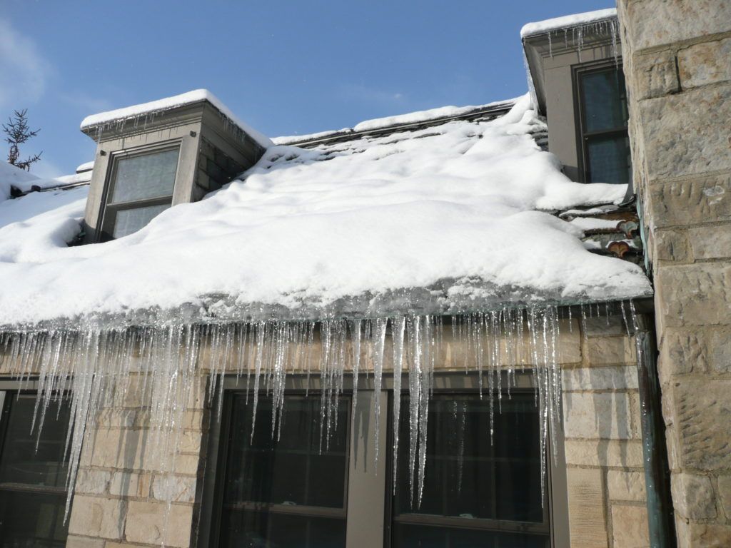 long icicles hanging from roof of prince george house, prevent ice damage with spray foam insulation