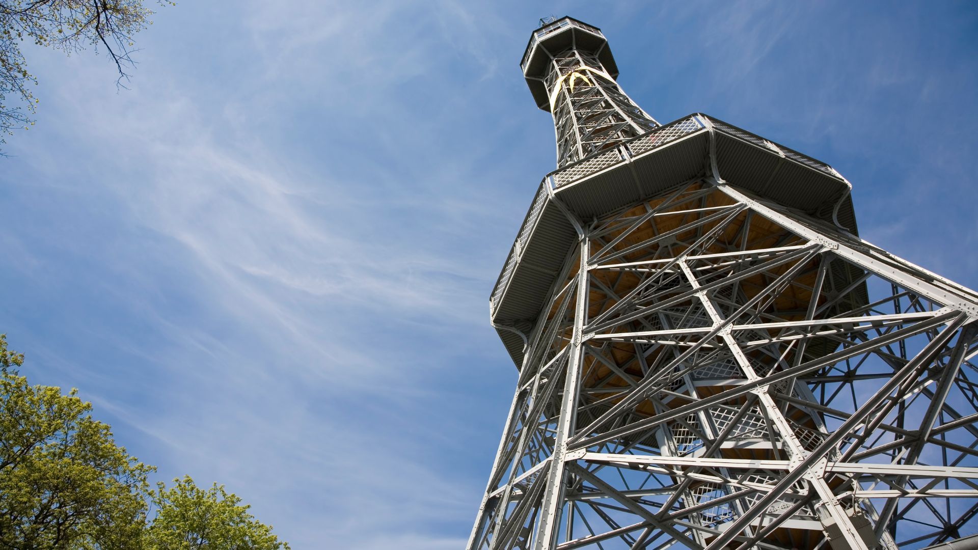 Metal lookout tower against a blue sky with whispy clouds.