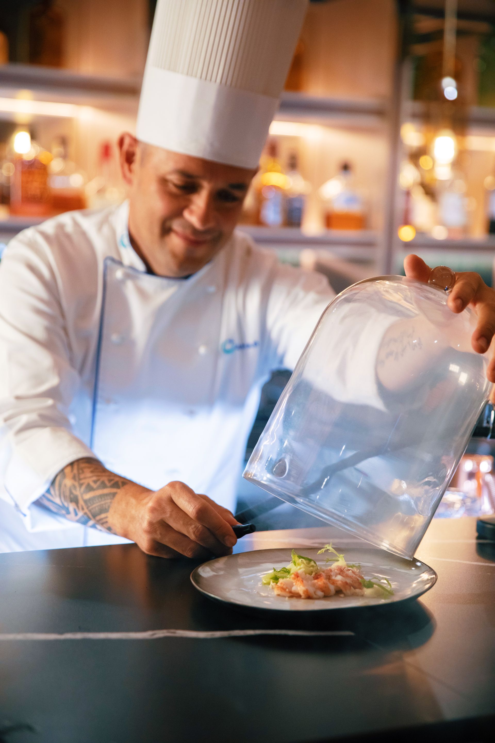 Chef Revealing a plate on a counter - Azamara Cruises Barter's Travelnet