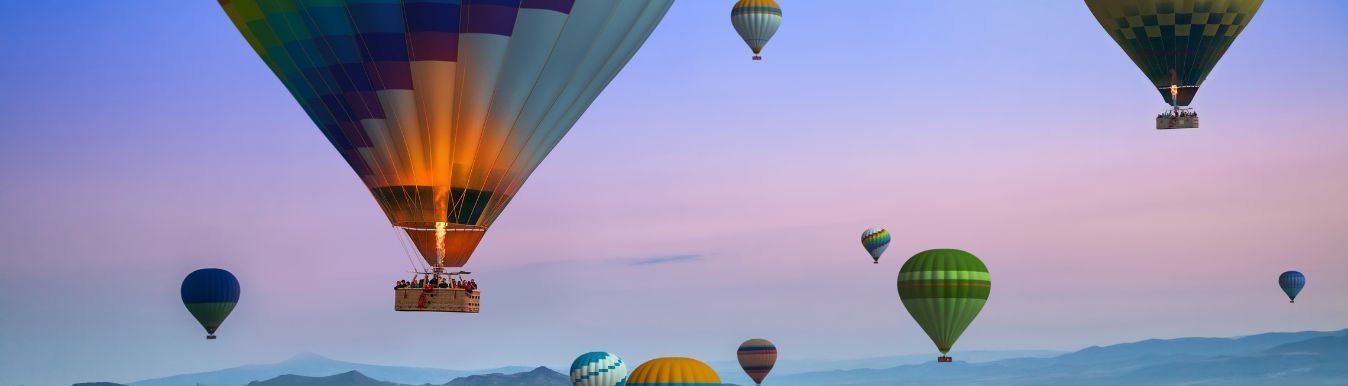 A group of hot air balloons are flying in the sky.