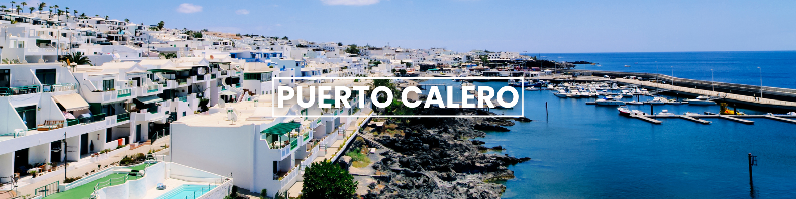 an aerial view of puerto calero , a small town on the coast of spain .Barter'sTravelnet