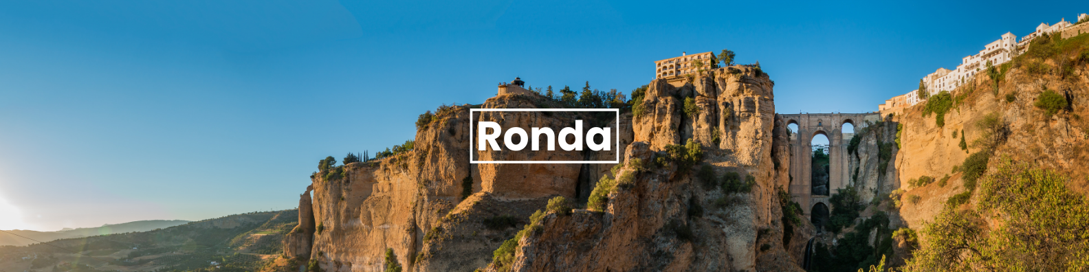 a bridge over a cliff with the word ronda on it . Barter'sTravelnet