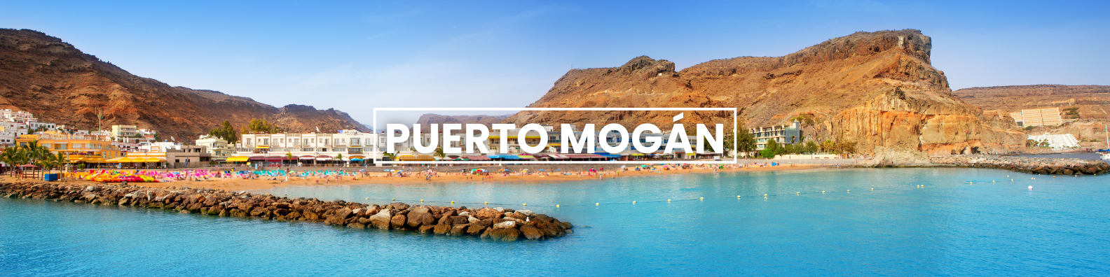 a blurred image of a beach with the words puerto mogan written on it . Barter's Travelnet