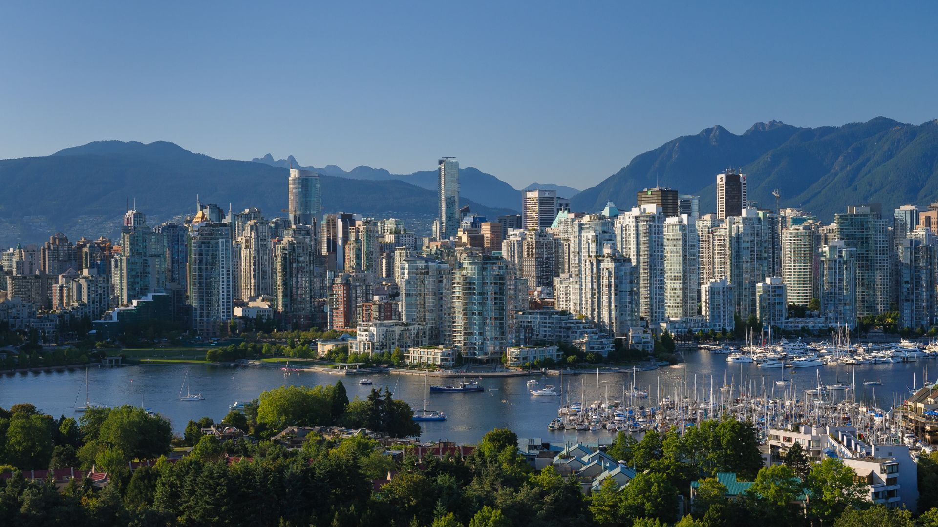 An aerial view of Vancouver skyline with mountains in the background