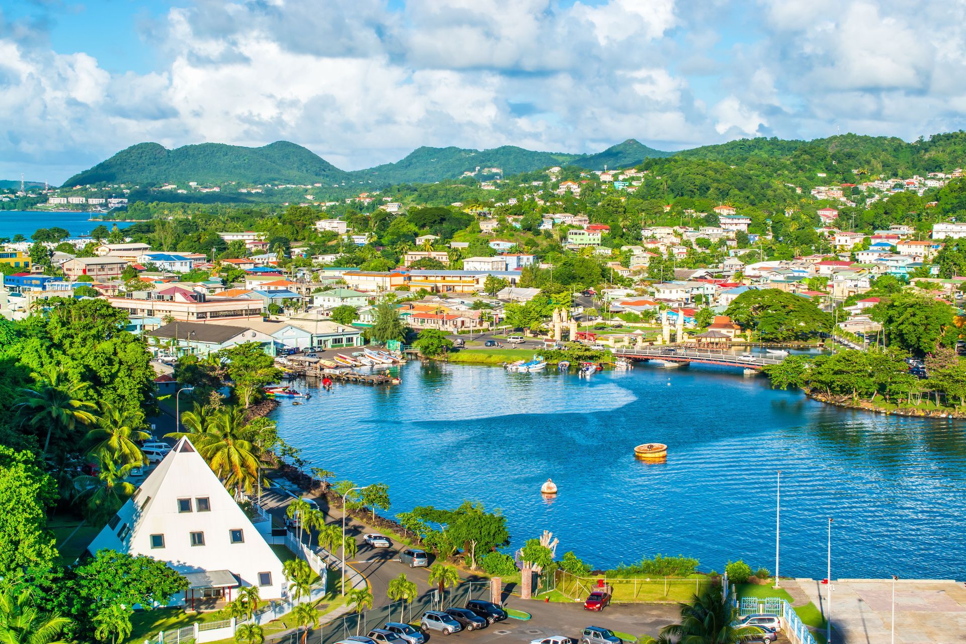 An aerial view of a city surrounded by water and mountains.