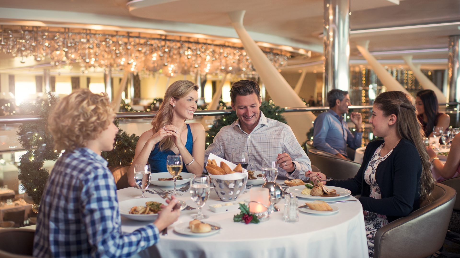 A family is sitting at a table in a restaurant eating food.