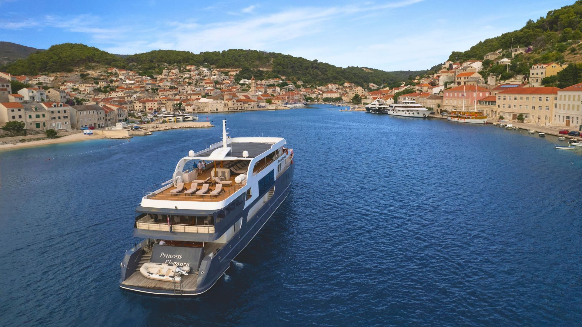 A large yacht is floating on top of a body of water