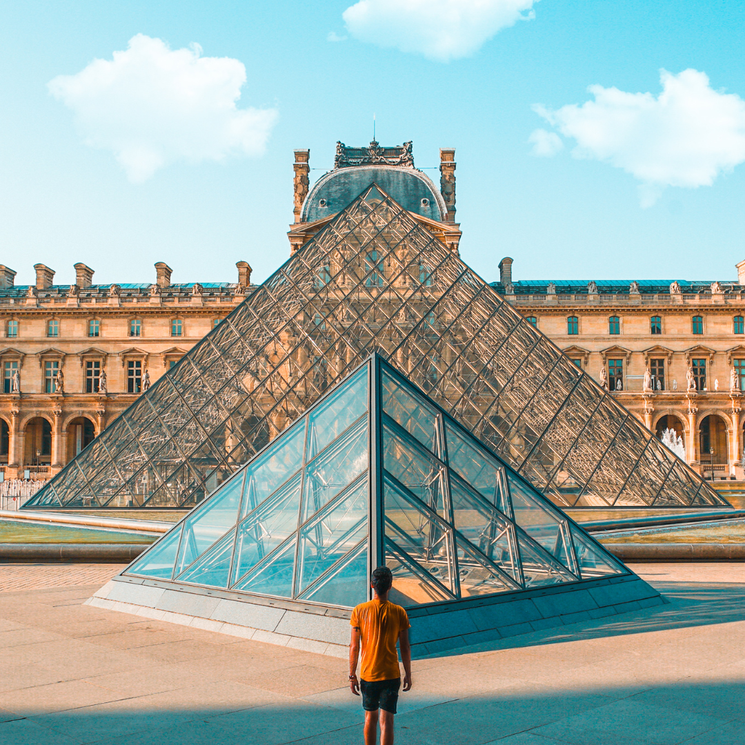Person in front of the Louvre Pyramid, Louvre Museum, Paris, France - Paris Holidays Barter's Travelnet