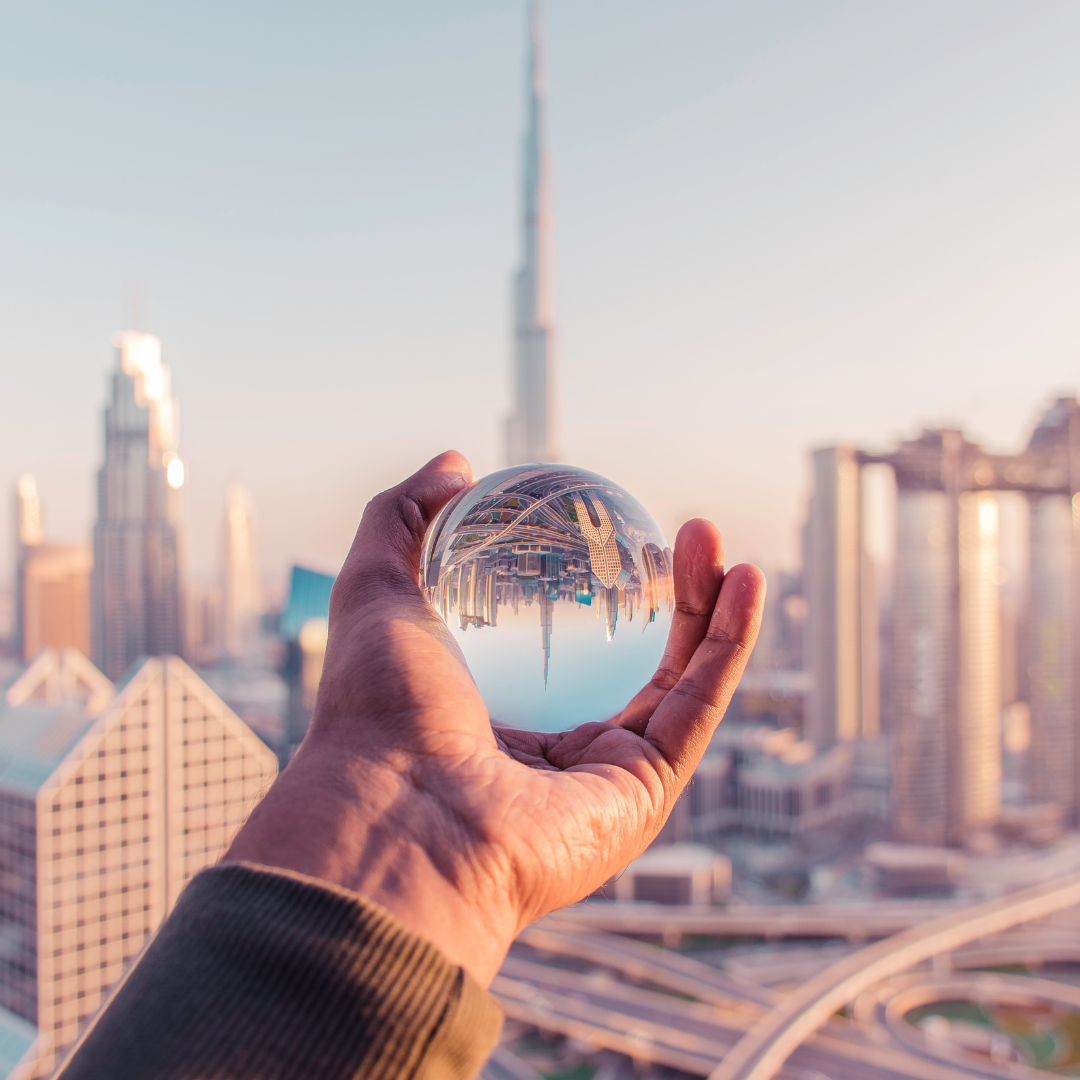 Crystal Glass Ball Transparent Ball pointing to The Burj Khalifa, a Skyscraper in Dubai, United Arab Emirates - Dubai Holidays Barter's Travelnet
