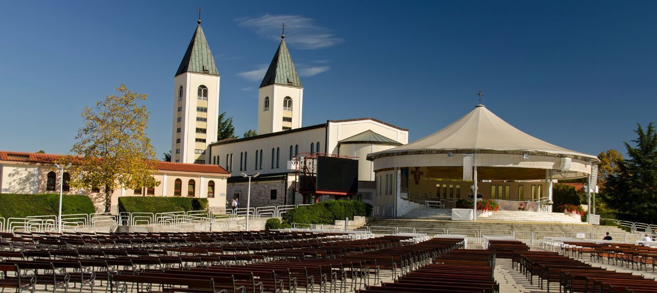 Medjugorje church with two towers and a stage in front of it.