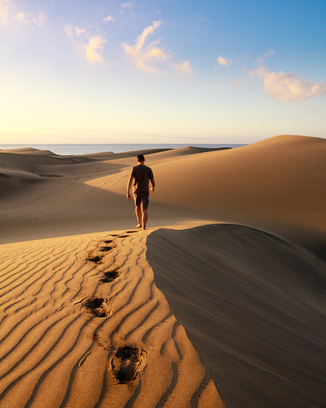 Man Walking on the Maspalomas Dunes, Sand Dunes Located On The South Coast of The Island of Gran Canaria, Province of Las Palmas, in the Canary Islands, Spain - Gran Canaria Holidays Barter's Travelnet