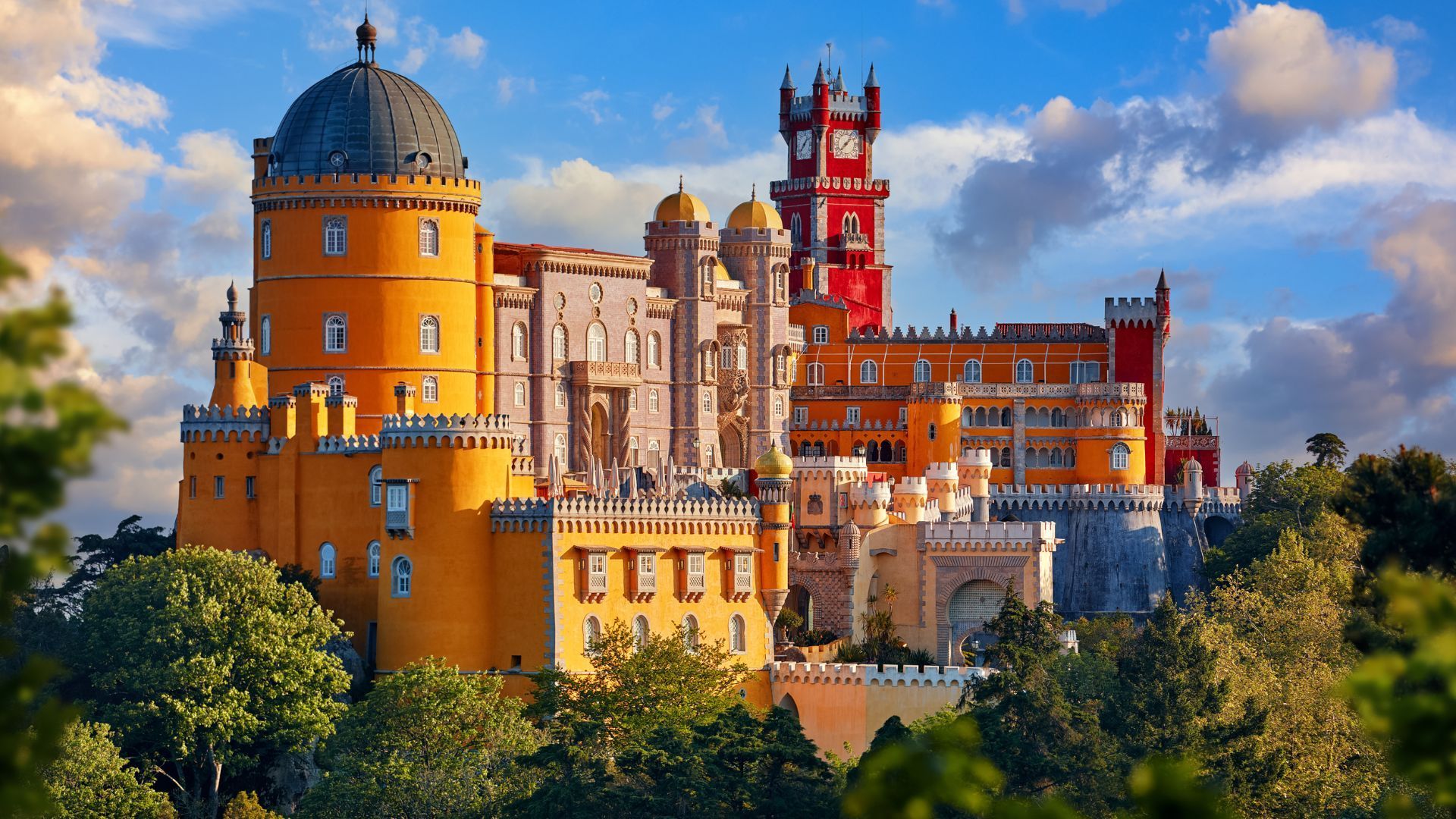 Pena Palace in Sintra, Portugal, a colorful castle on a hilltop with yellow, red, and blue towers.