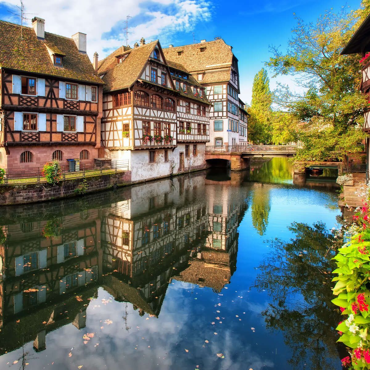 A reflection of a building in a body of water