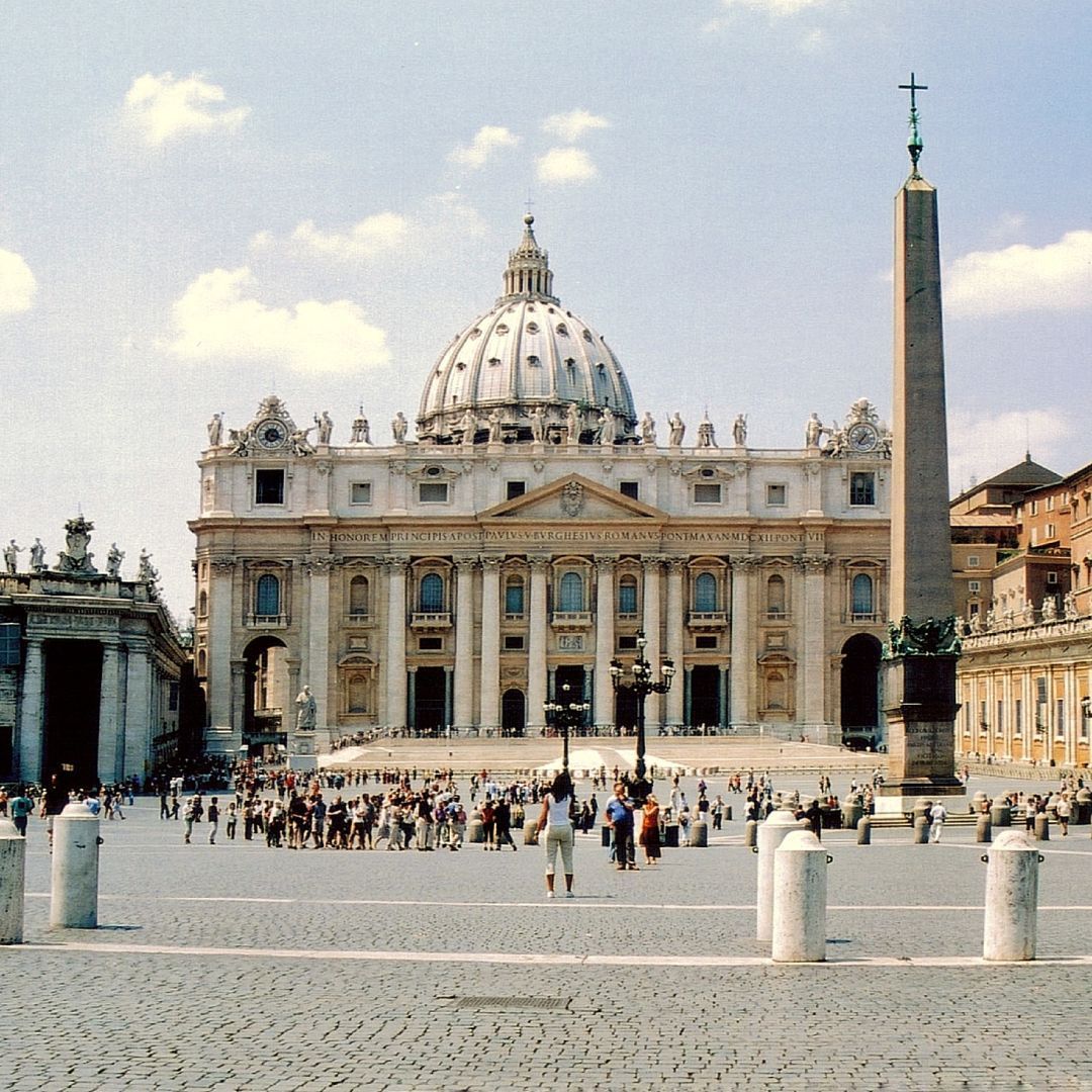 The papal Basilica of Saint Peter in the Vatican City with a dome and a cross on top