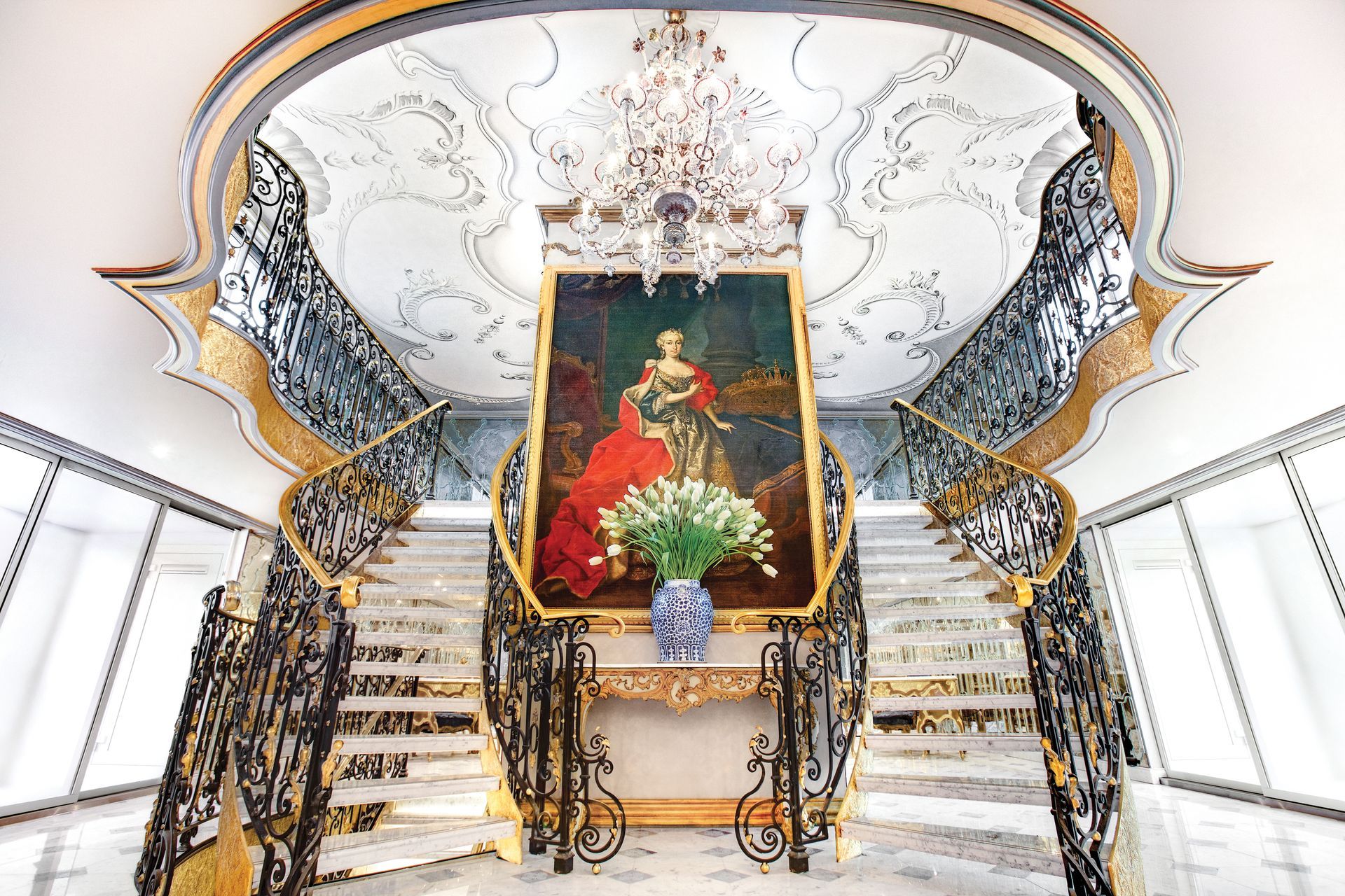 Luxurious Lobby Details Cruise with a Big painting and stairs on the sides - Uniworld River Cruises Barter's Travelnet