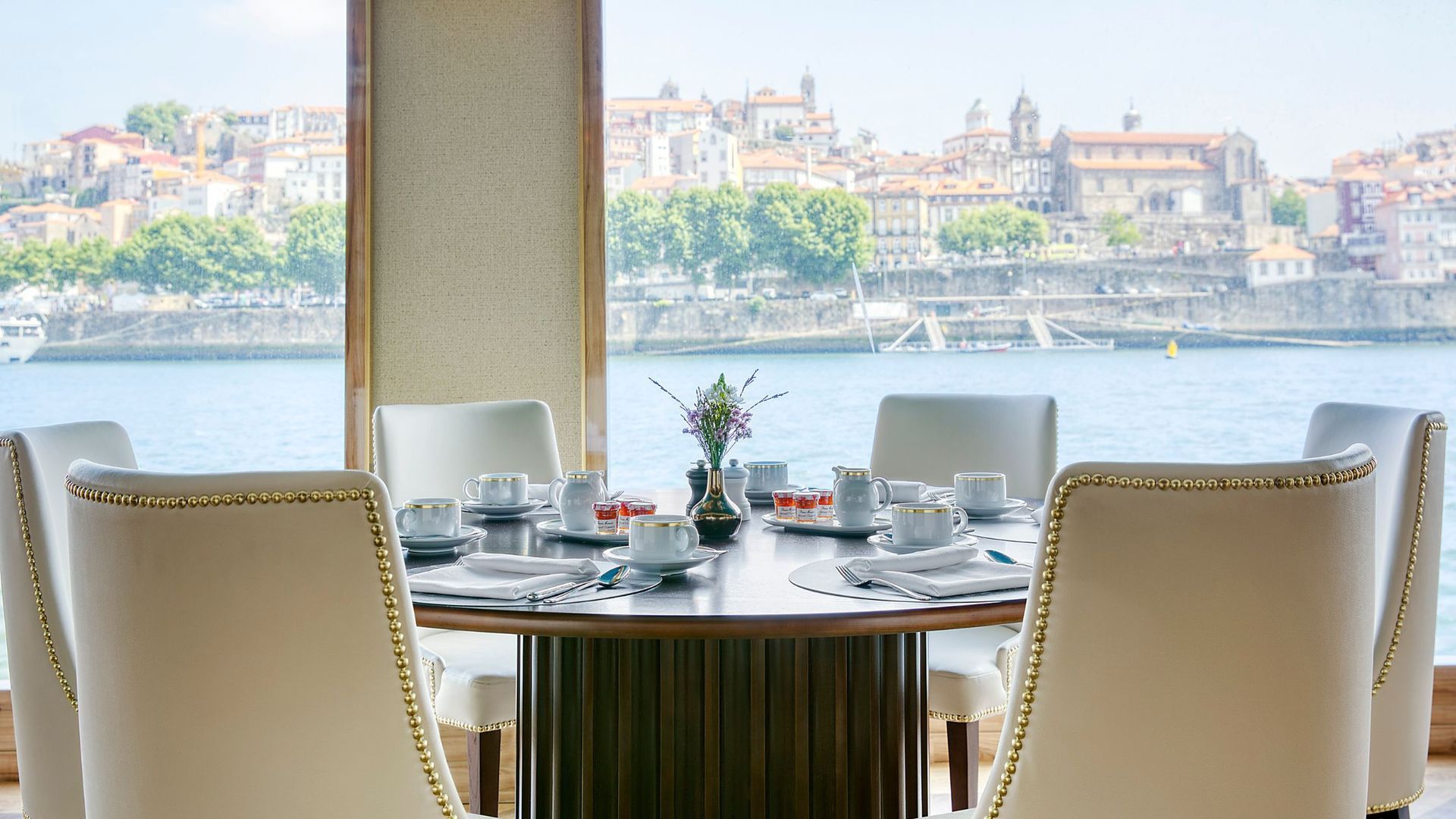 SS São Gabriel River Cruise, A dining room table and chairs with a view of the water