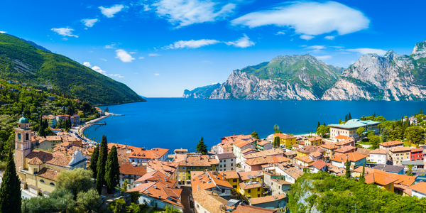 Beautiful Panoramic view of Lake Garda in Italy with a village and mountains in the background, Italian Riviera - Blog Post Barters Travelnet