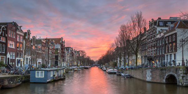 The Herengracht Canal during sunset in Amsterdam, Netherlands - Blog Post Barters Travelnet