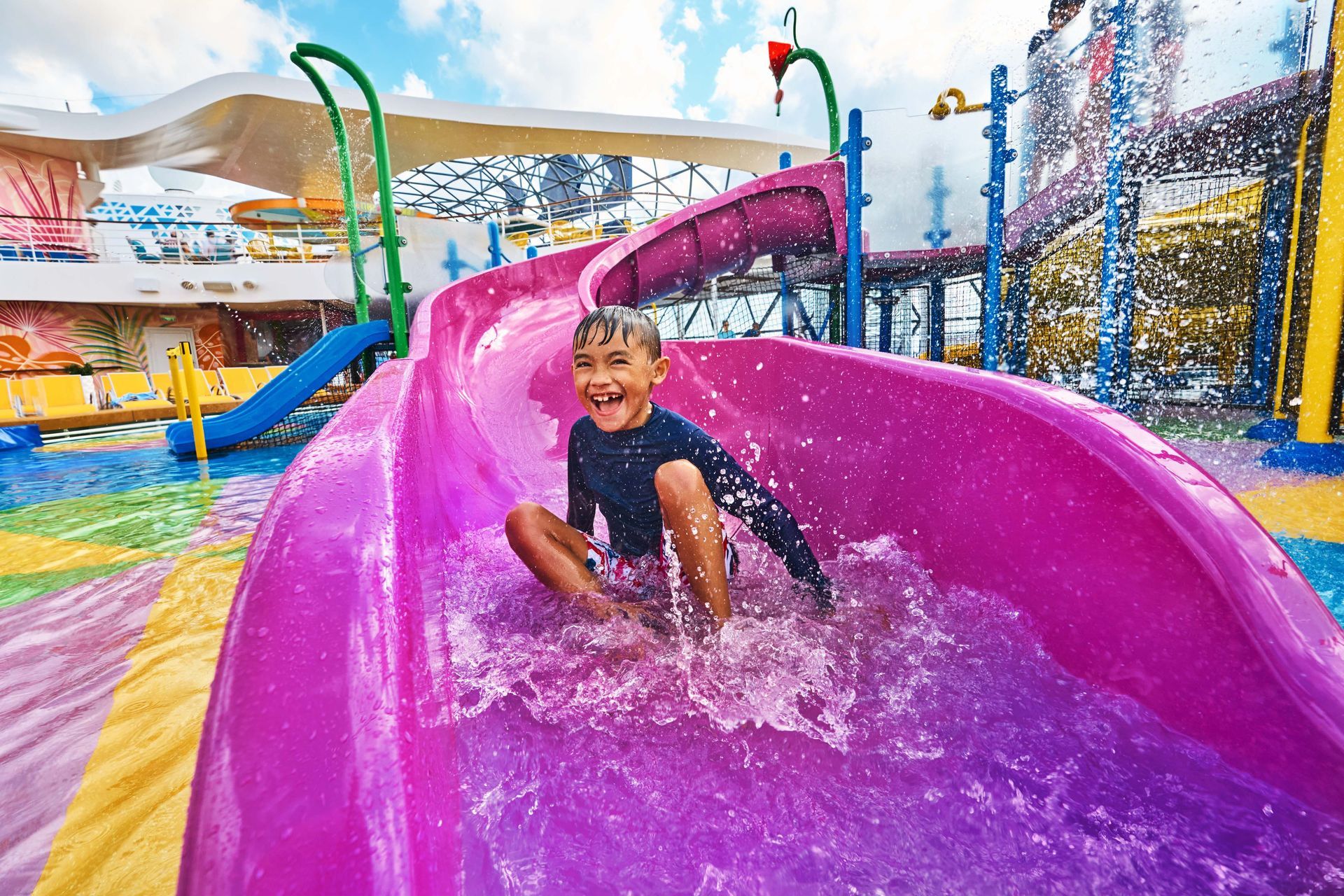 Kid Slidding a Water Slide Utopia of the Seas Cruise - Royal Caribbean Holidays Barter's Travelnet