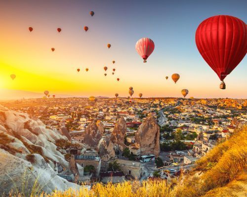 turkey town view with hot air balloons in the sky at sunset