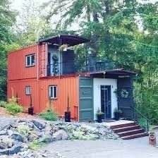 two story cargo container home in the woods