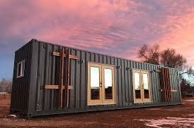 green shipping container at sunset