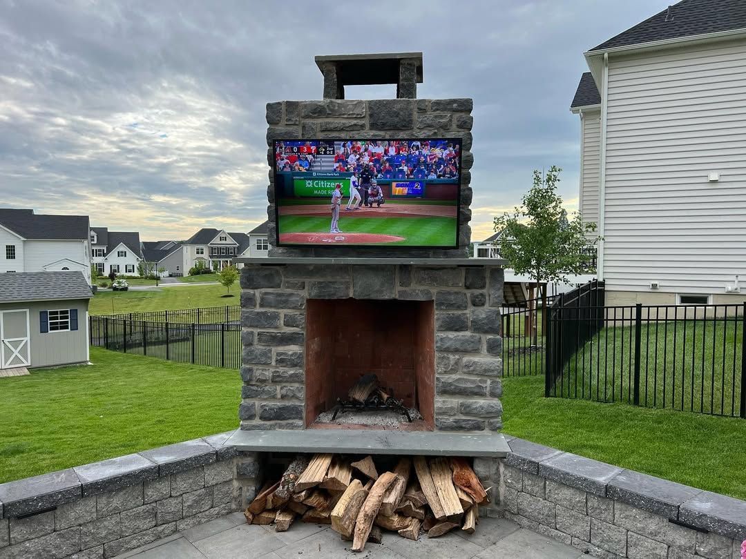 A fireplace with a television mounted on top of it.