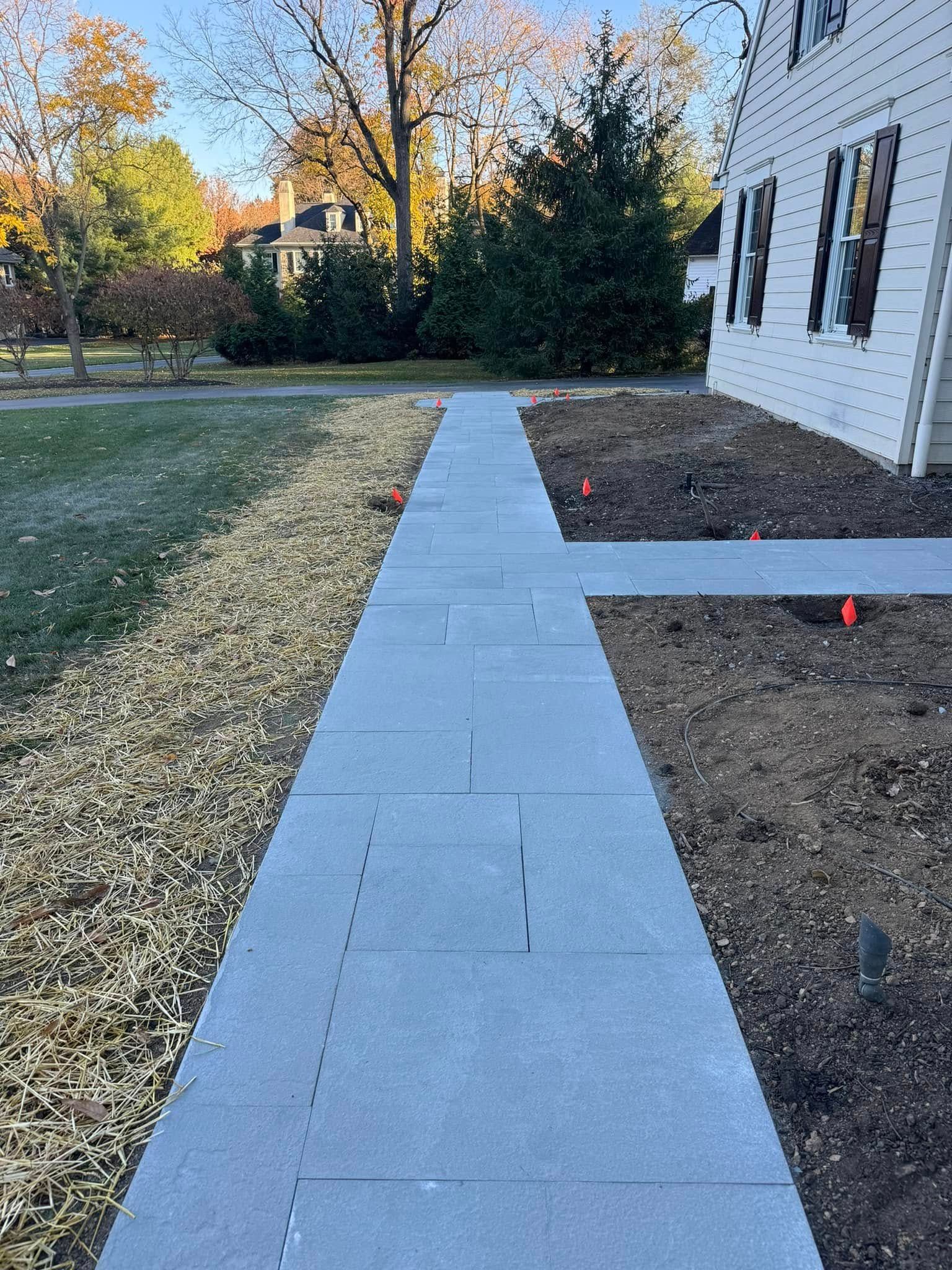 A sidewalk is being built in front of a house.