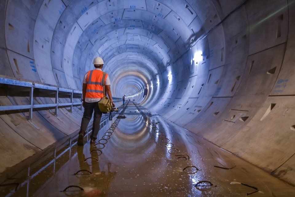 contractor walking in a tunnel