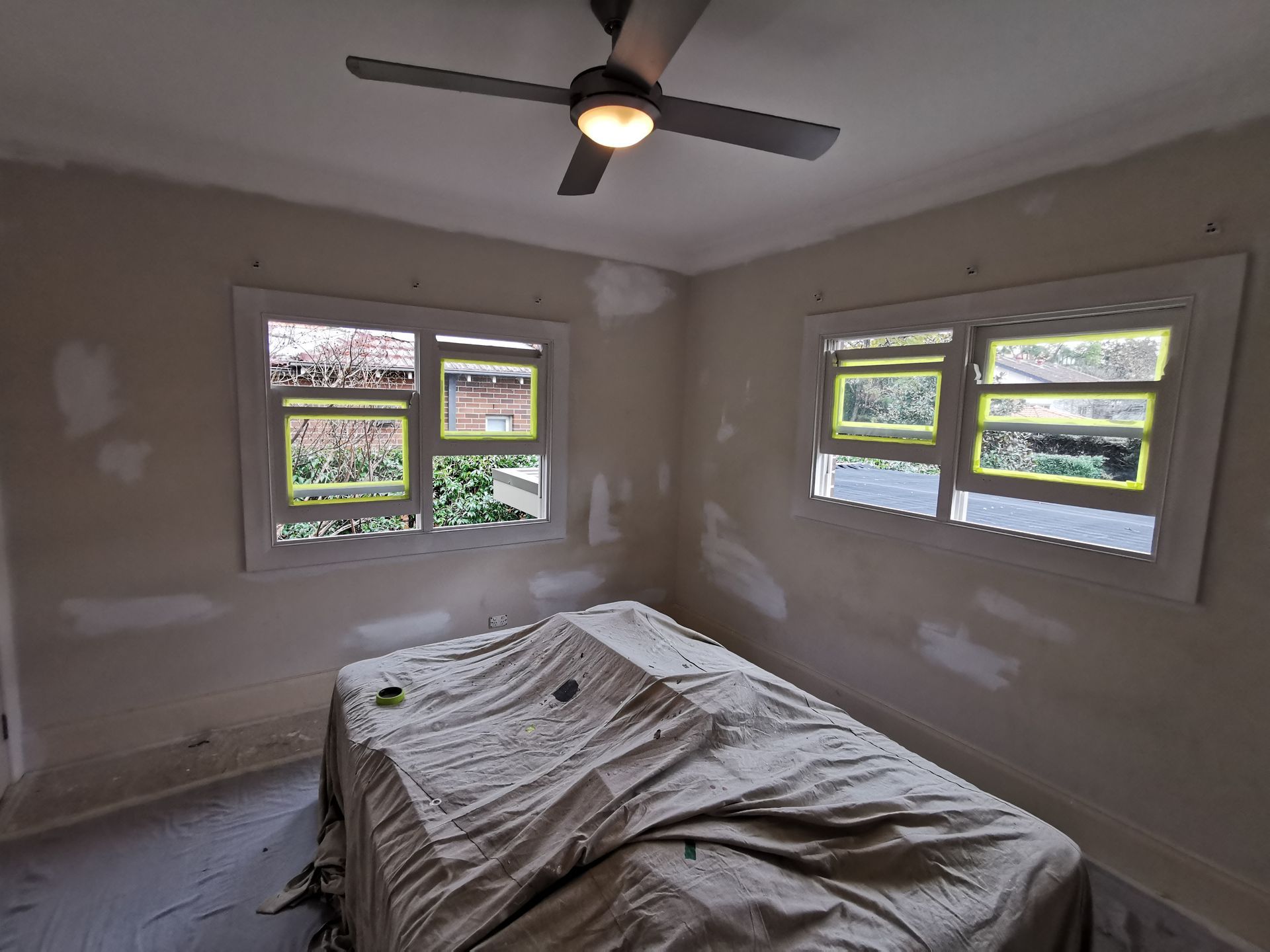 A Patched Bedroom With A Bed And A Ceiling Fan — Hornsby, NSW — TOG Painting