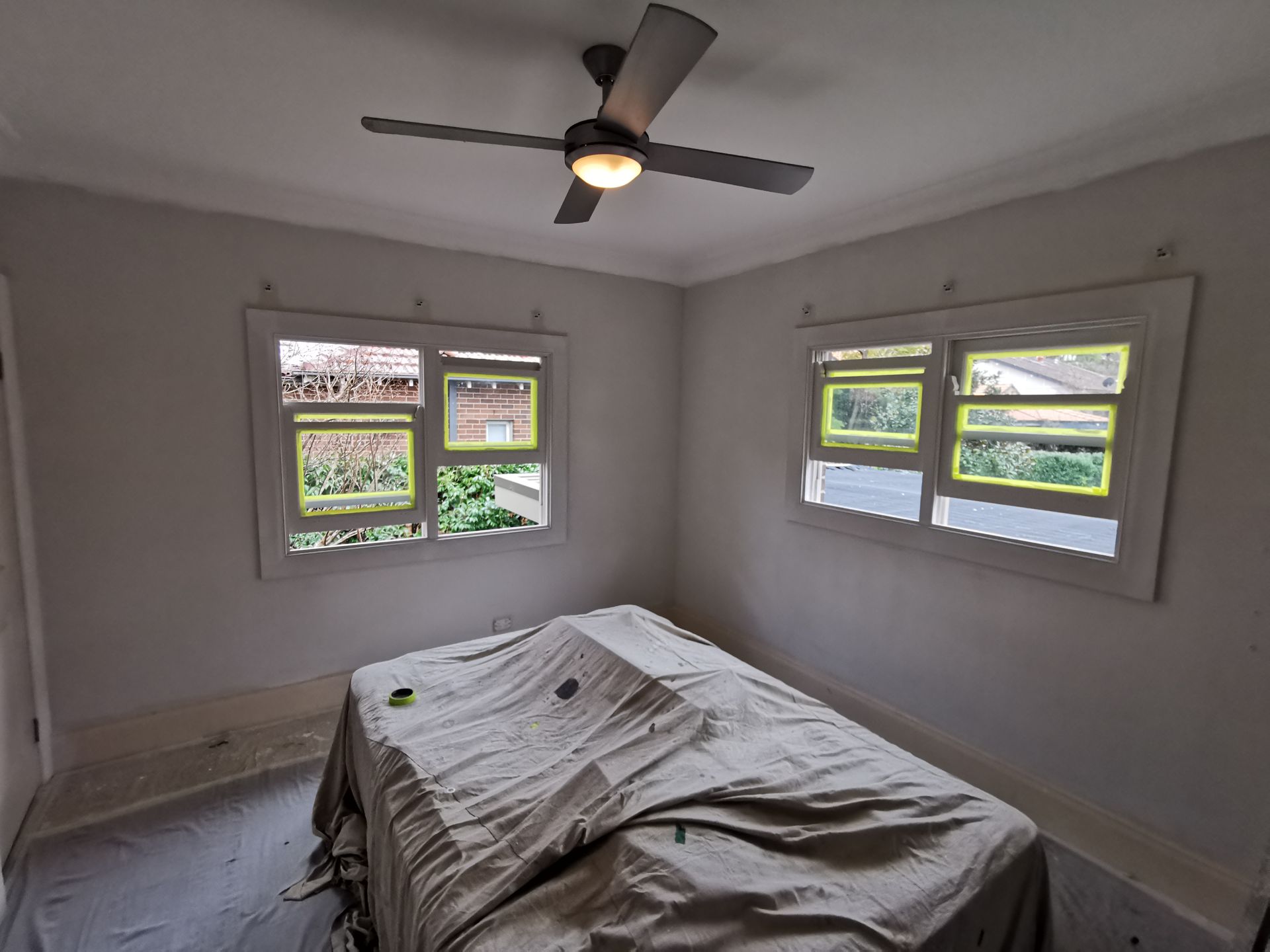 A Bedroom With A Bed And A Ceiling Fan — Hornsby, NSW — TOG Painting
