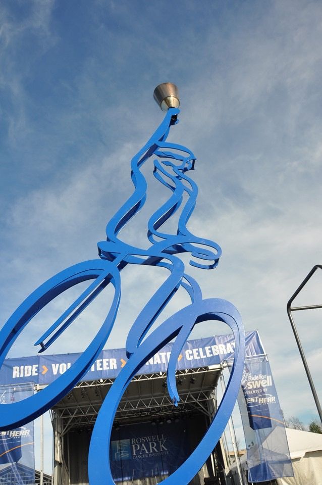 A Large Blue Sculpture of a Person Riding a Bike - Jamestown, NY - Colburns A/C & R, Inc.