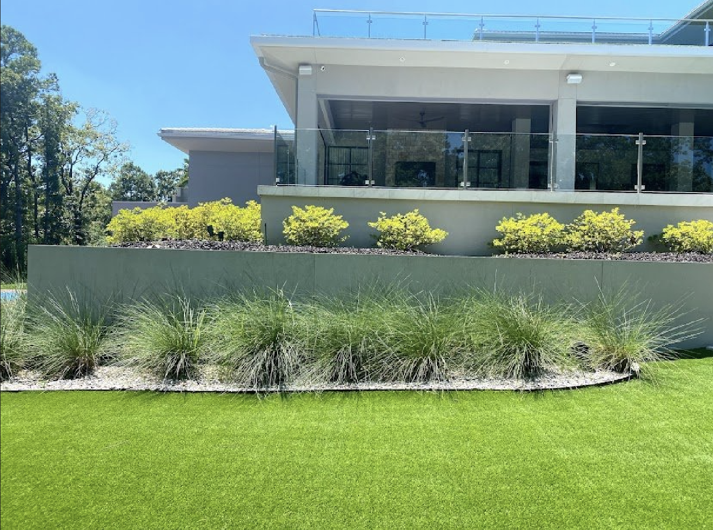 A large house with a lush green lawn in front of it.
