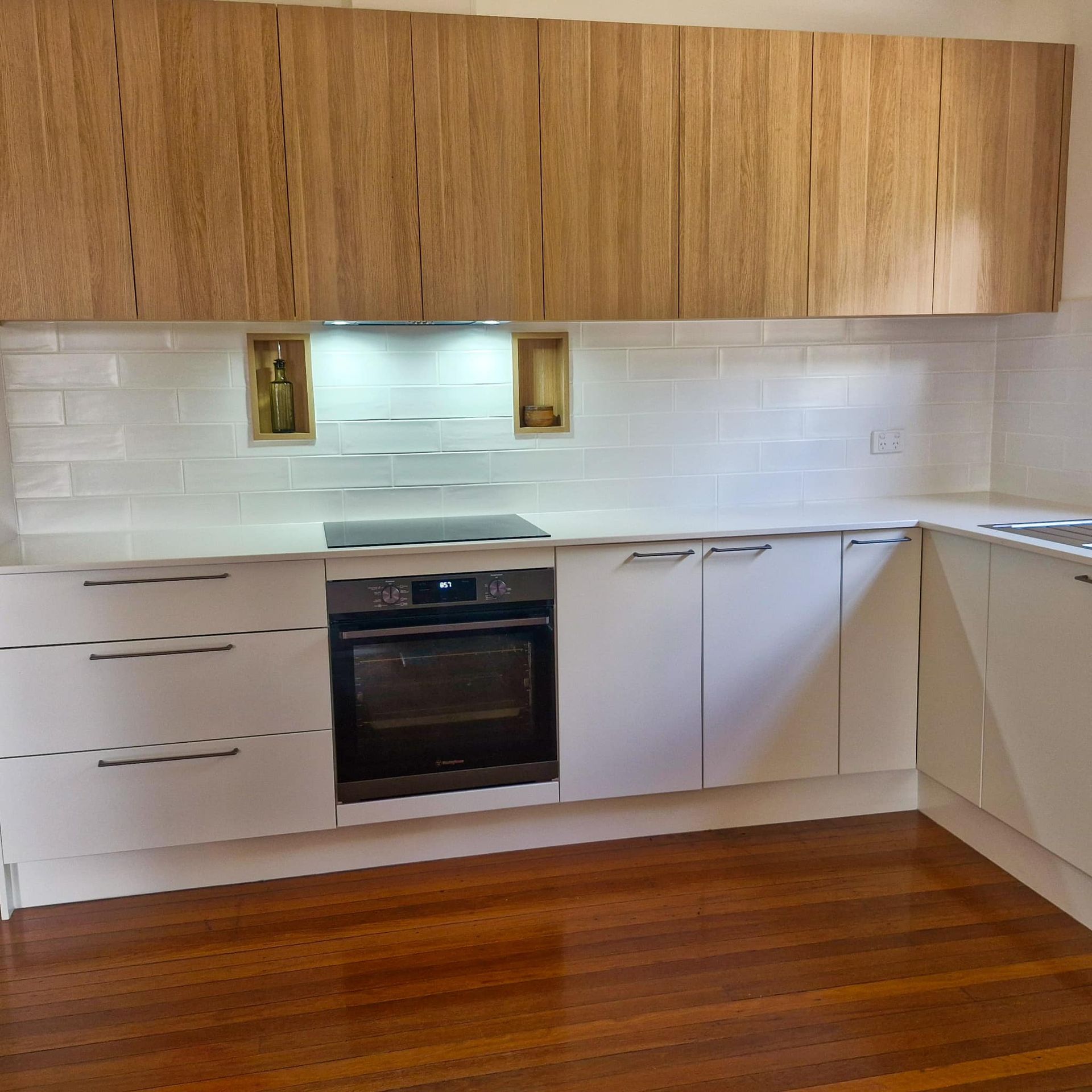 A Hallway With Shelves and a Door Leading to a Bedroom — Coastal Detail Joinery in Taree, NSW