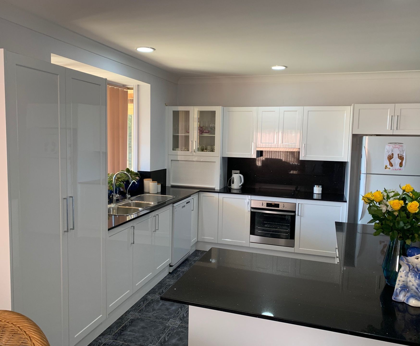 A Kitchen With White Cabinets and a Stove Top Oven — Coastal Detail Joinery in Tuncurry, NSW