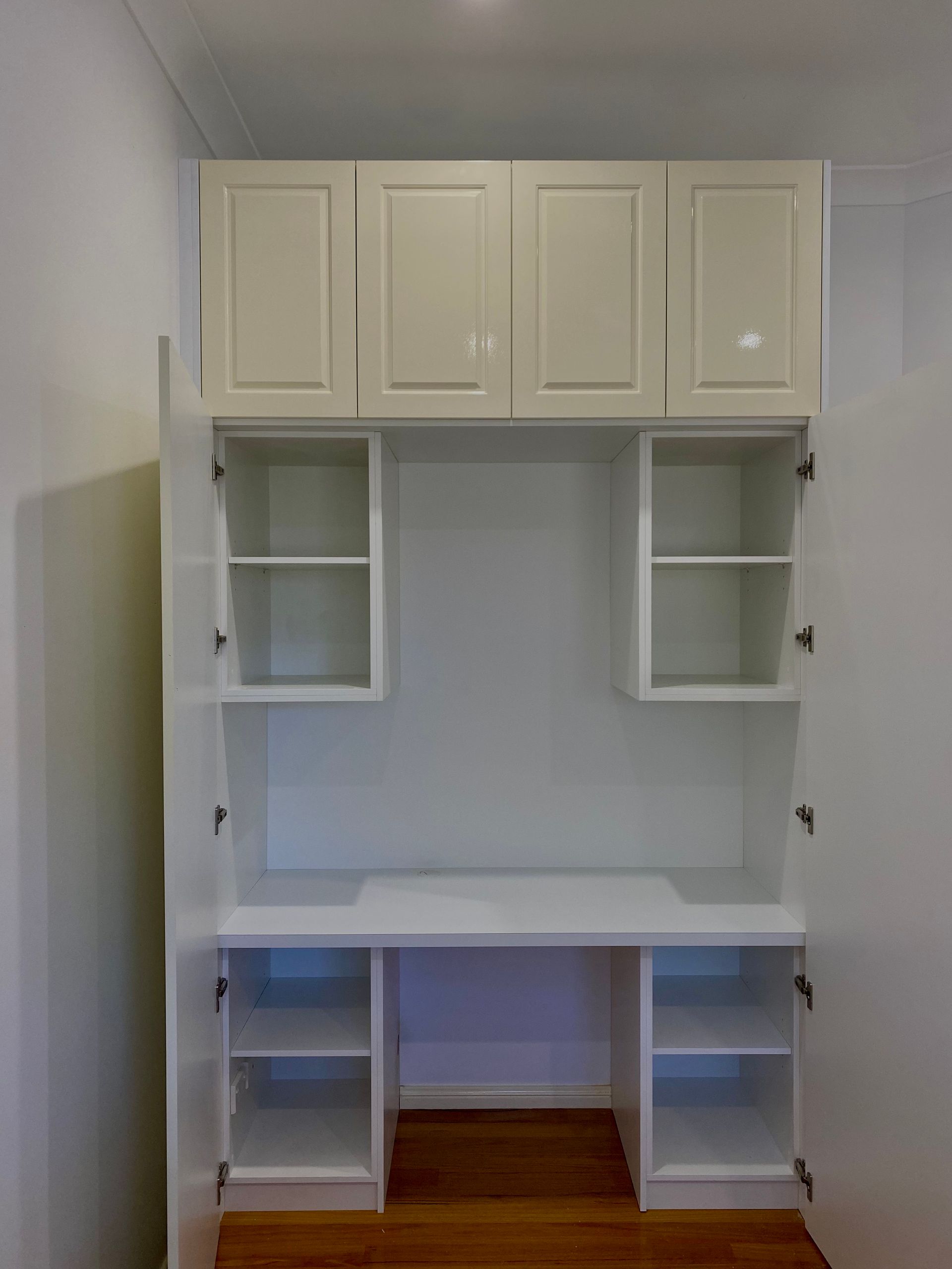 A white cabinet with the doors open and a desk underneath it — Coastal Detail Joinery in Tuncurry, NSW