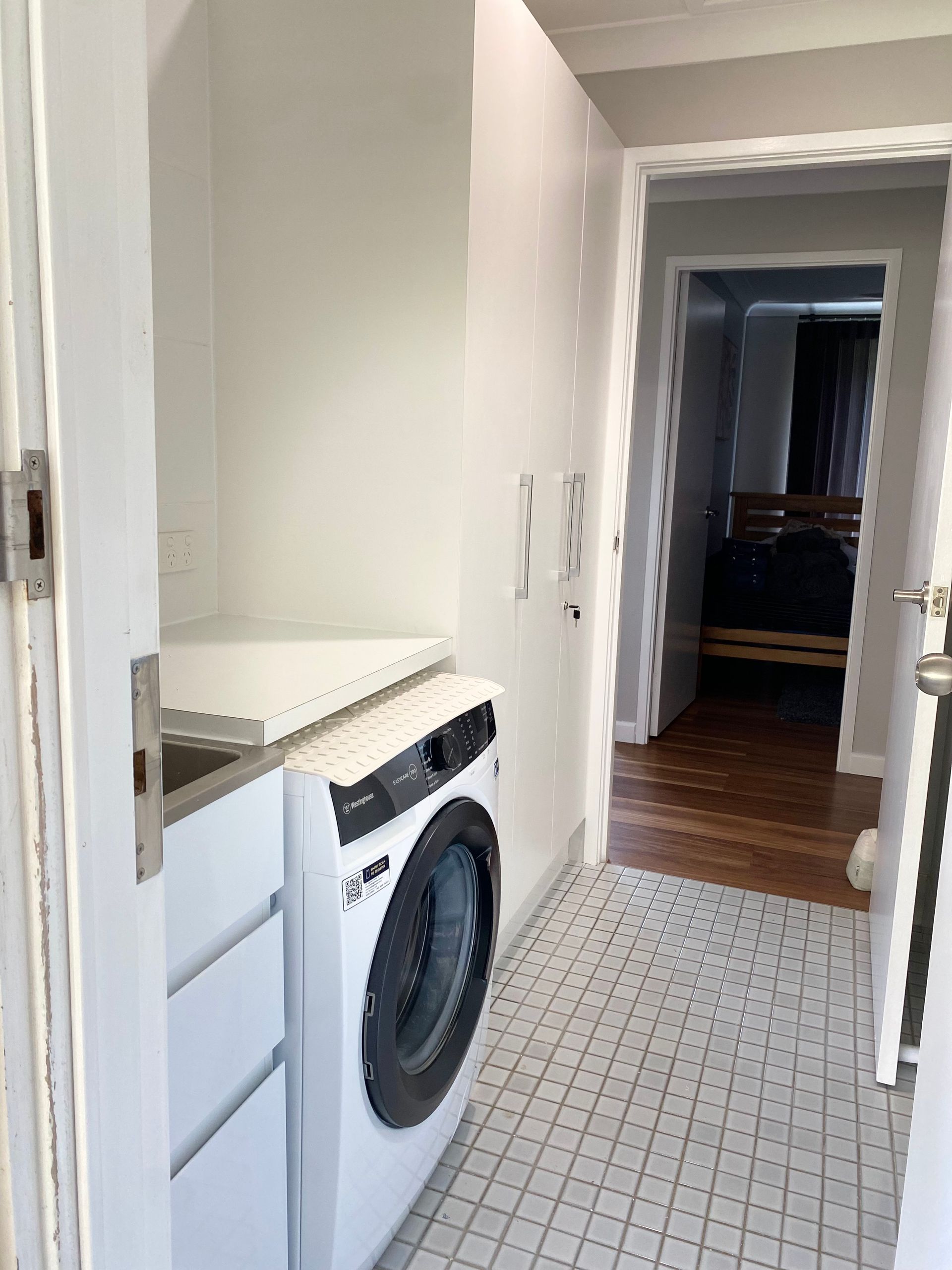 A laundry room with a washing machine and a sink — Coastal Detail Joinery in Tuncurry, NSW