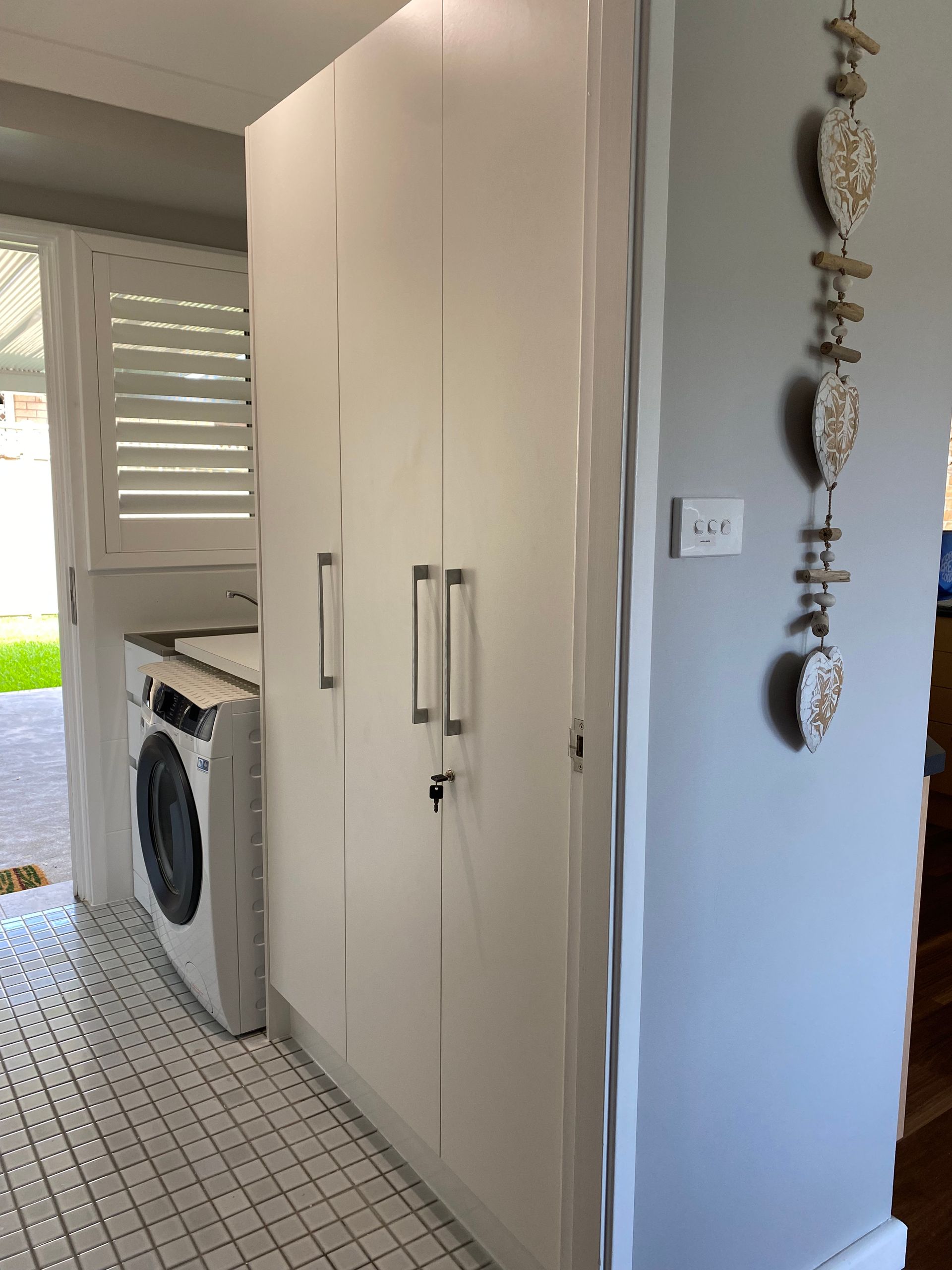 There is a washer and dryer in the laundry room — Coastal Detail Joinery in Tuncurry, NSW