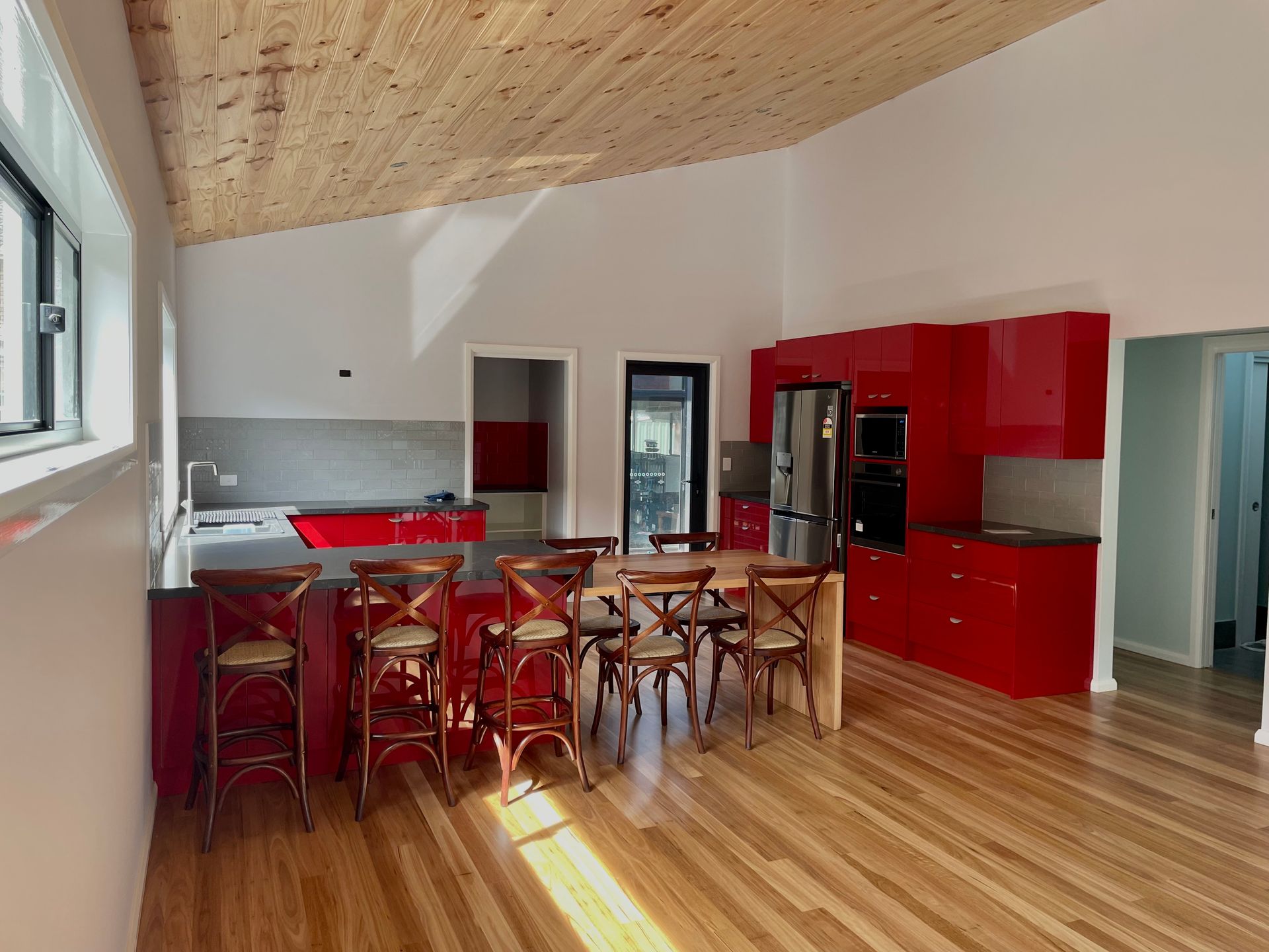A Kitchen With White Cabinets and a Stove Top Oven — Coastal Detail Joinery in Harrington, NSW