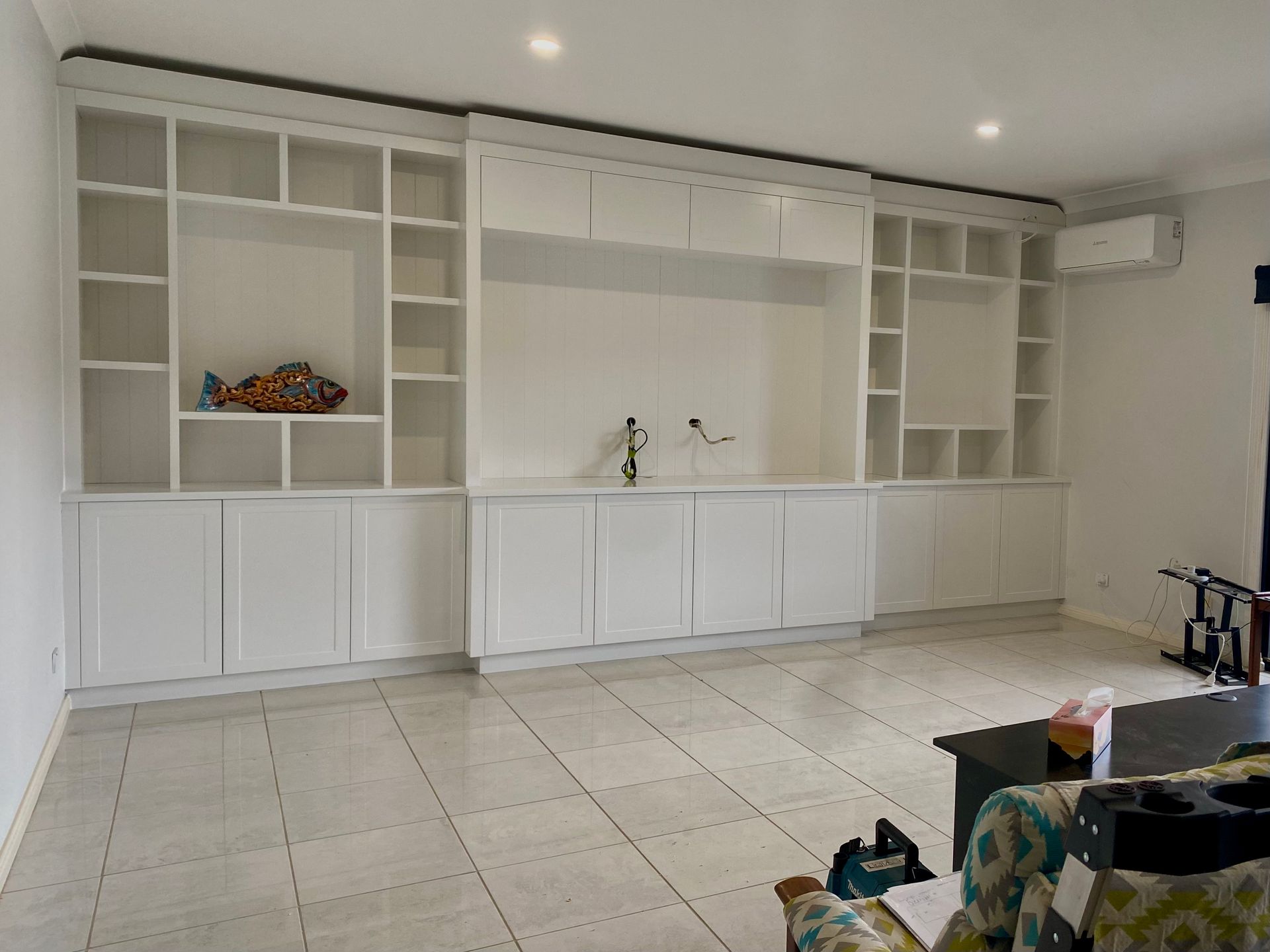 A living room with a lot of shelves and a couch — Coastal Detail Joinery in Tuncurry, NSW