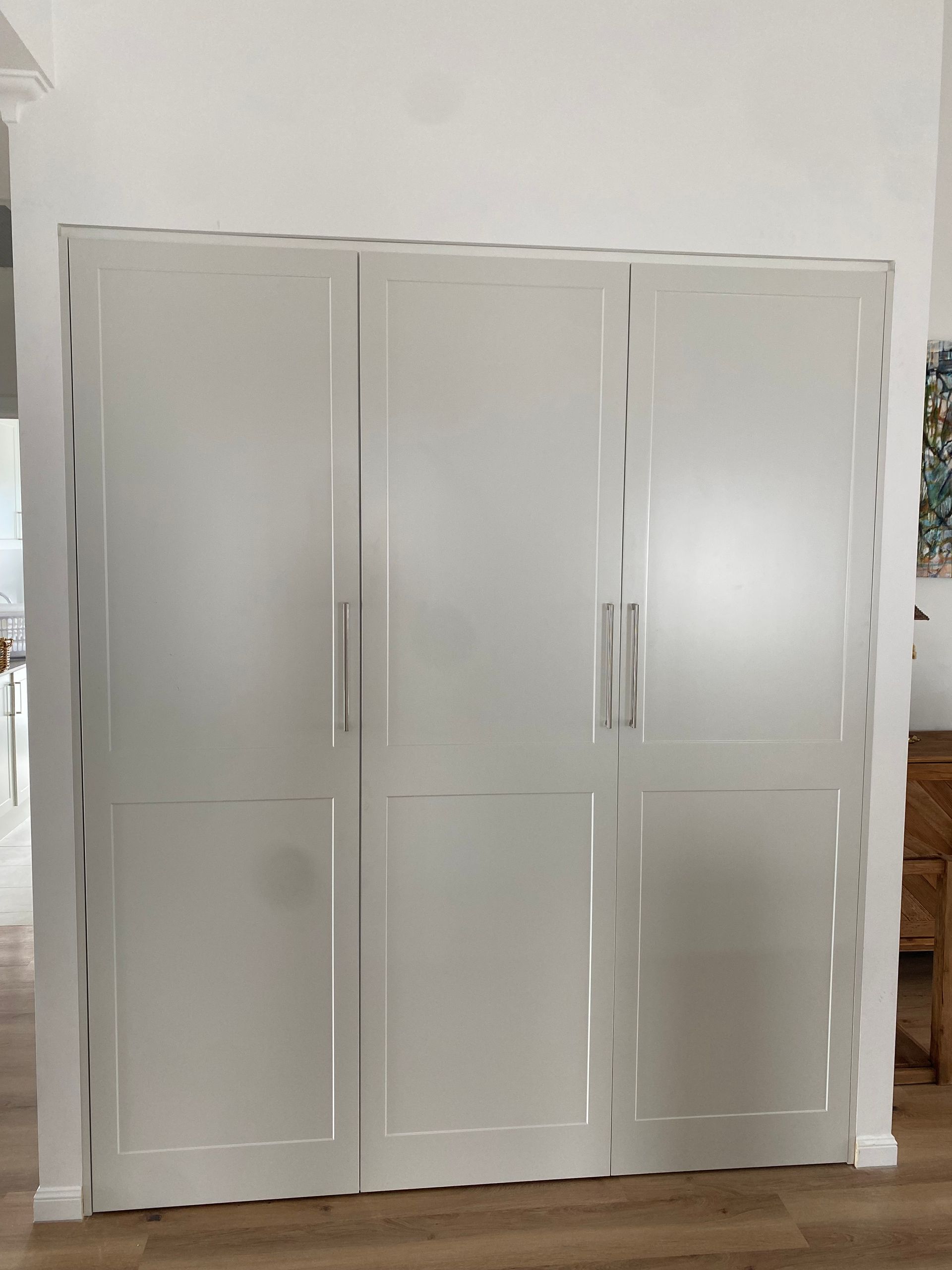 A large white cabinet is sitting in a room next to a wall — Coastal Detail Joinery in Tuncurry, NSW