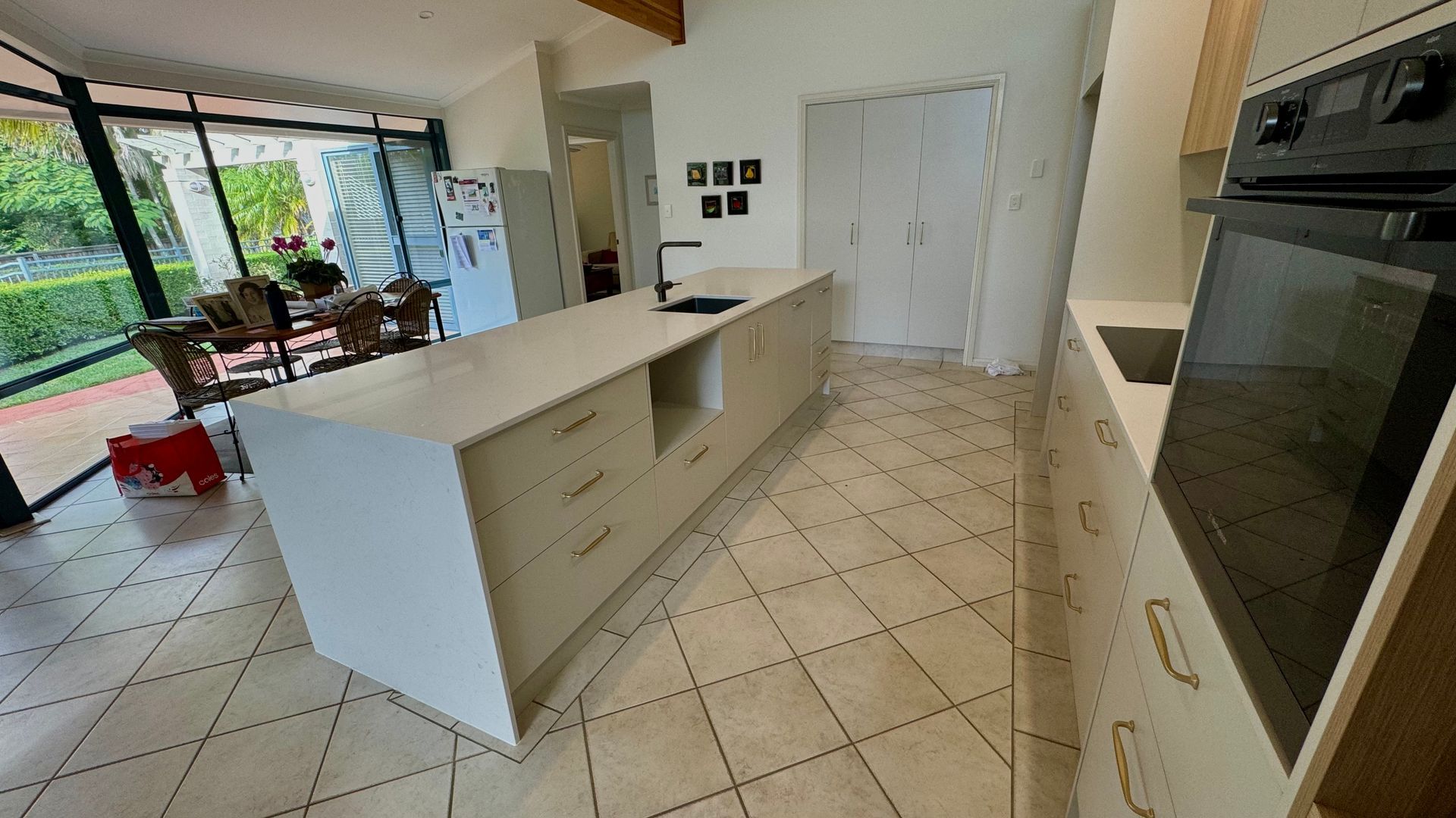 A kitchen with a large island in the middle of the room — Coastal Detail Joinery in Tuncurry, NSW